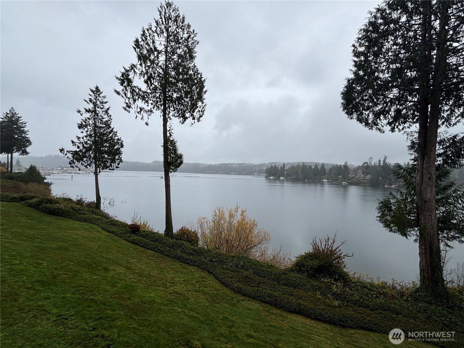 221 North Bay Lane, Unit 2 Port Ludlow, WA 98365 - Photo 34 of 35 a view of a lake with a big yard and palm trees