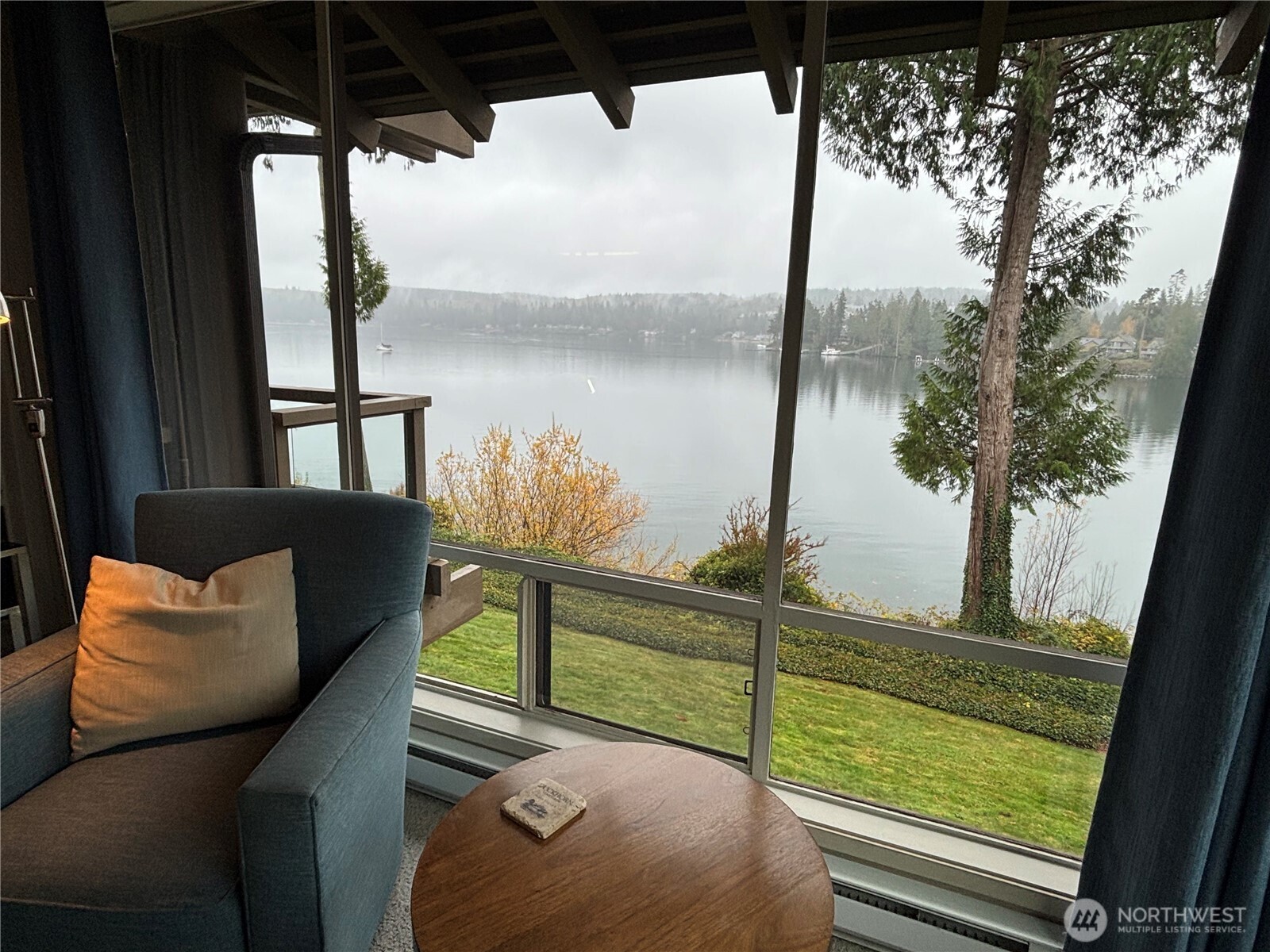 221 North Bay Lane, Unit 2 Port Ludlow, WA 98365 - Photo 9 of 35 a view of a porch with furniture and a lake view
