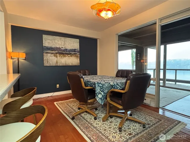 a living room with dining table and wooden floor