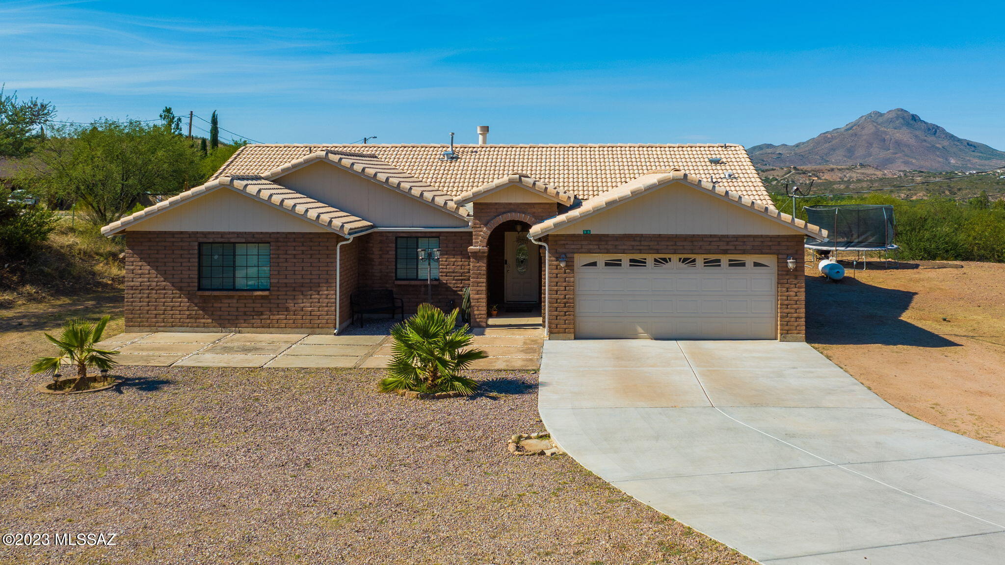 96 Calle Quintana Rio Rico, AZ 85648 - Photo 2 of 30 a front view of a house with a garden