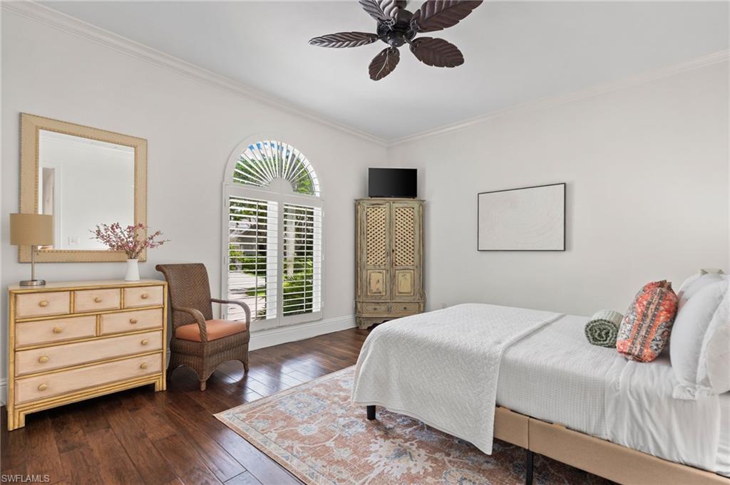 2201 Beacon Lane Naples, FL 34103 - Photo 16 of 25 a bedroom with a bed a dresser and a window