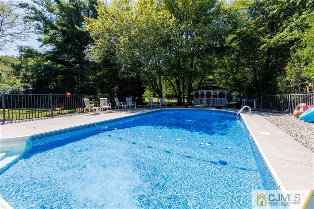 81 Spring Hill Road Old Bridge, NJ 07747 - Photo 11 of 40 a swimming pool with wooden fence