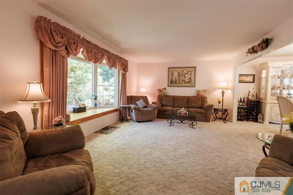 81 Spring Hill Road Old Bridge, NJ 07747 - Photo 16 of 40 a living room with furniture and a large window
