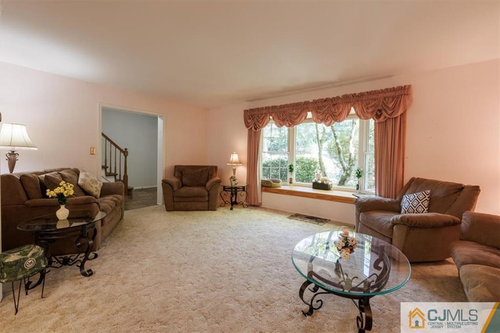 81 Spring Hill Road Old Bridge, NJ 07747 - Photo 17 of 40 a living room with furniture and a large window