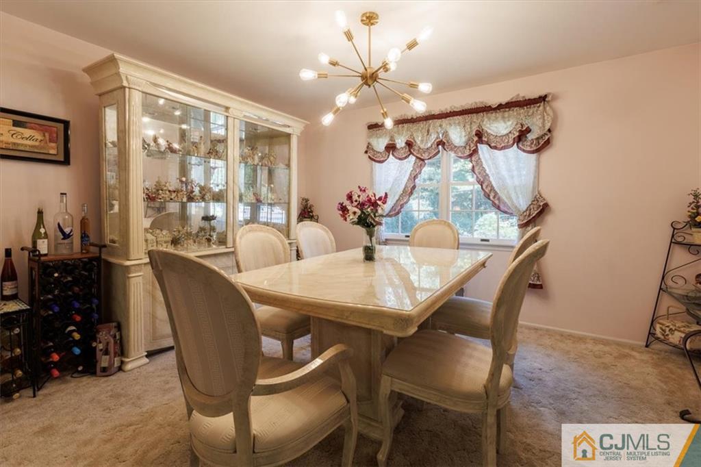 81 Spring Hill Road Old Bridge, NJ 07747 - Photo 18 of 40 a view of a dining room with furniture and chandelier