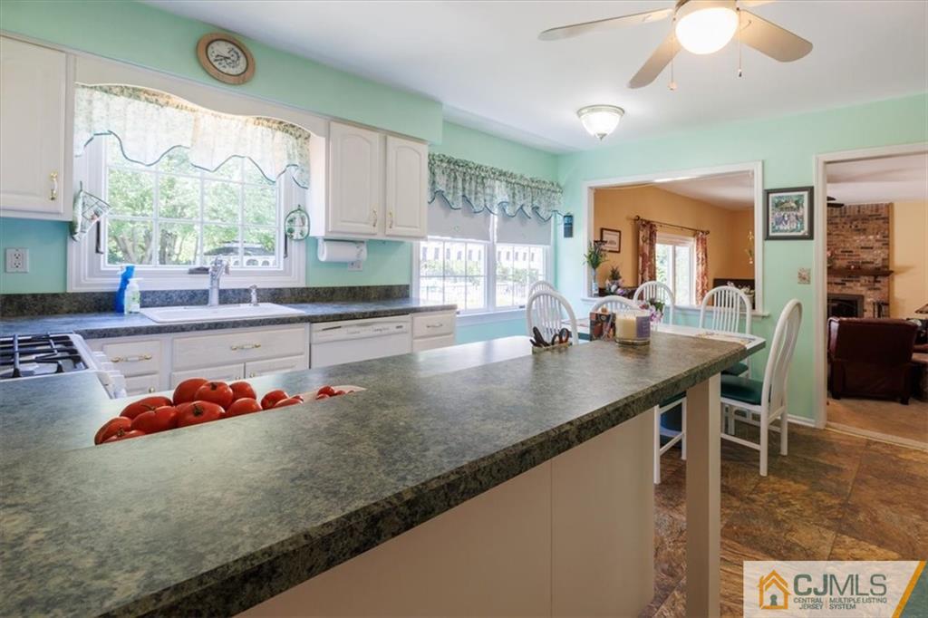 81 Spring Hill Road Old Bridge, NJ 07747 - Photo 20 of 40 a kitchen with stainless steel appliances granite countertop a sink a stove and a wooden cabinets