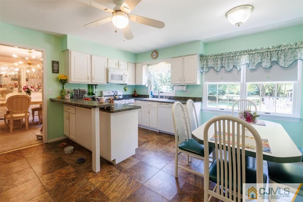 81 Spring Hill Road Old Bridge, NJ 07747 - Photo 21 of 40 a kitchen with a sink a stove a table and chairs