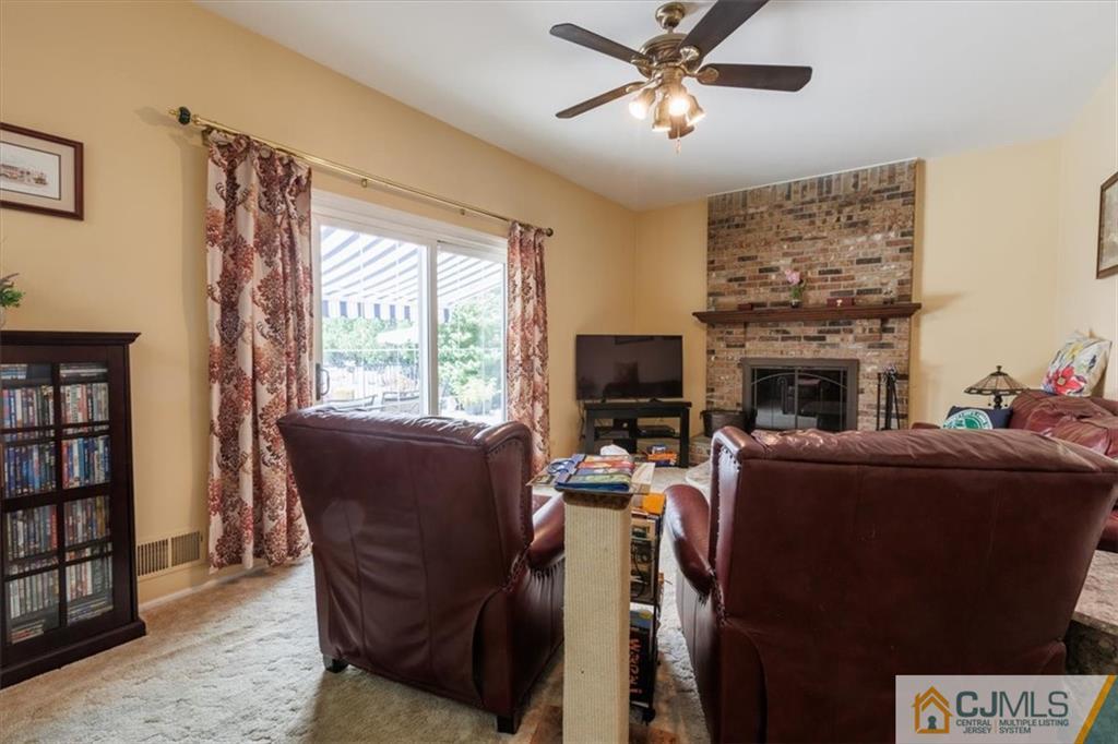 81 Spring Hill Road Old Bridge, NJ 07747 - Photo 23 of 40 a living room with furniture a flat screen tv and a fireplace