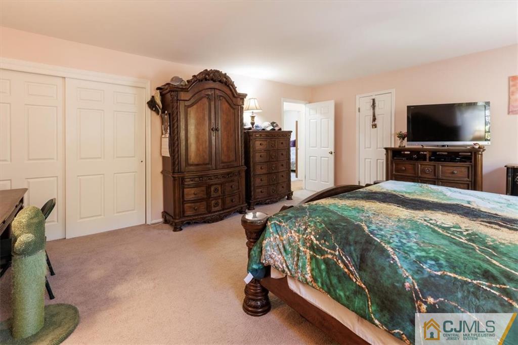 81 Spring Hill Road Old Bridge, NJ 07747 - Photo 31 of 40 a bedroom with a bed and a flat screen tv
