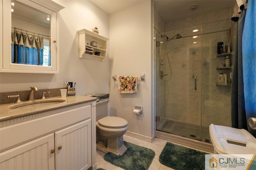 81 Spring Hill Road Old Bridge, NJ 07747 - Photo 32 of 40 a bathroom with a granite countertop sink toilet and shower