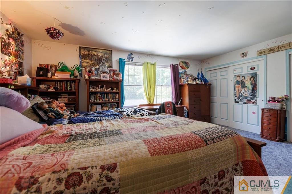 81 Spring Hill Road Old Bridge, NJ 07747 - Photo 35 of 40 a bedroom with a bed a dresser and a large mirror
