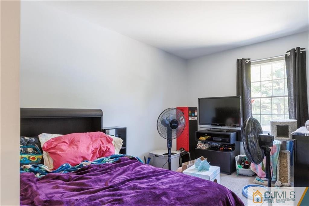 81 Spring Hill Road Old Bridge, NJ 07747 - Photo 38 of 40 a bedroom with a bed and a flat screen tv