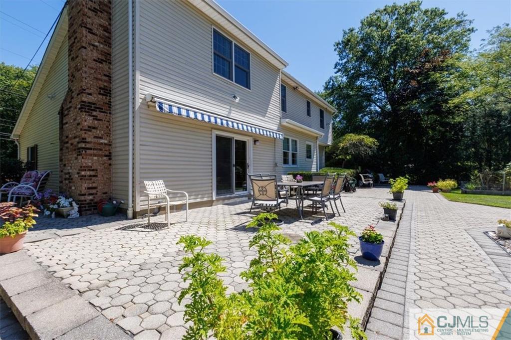 81 Spring Hill Road Old Bridge, NJ 07747 - Photo 4 of 40 a view of a patio with table and chairs and potted plants
