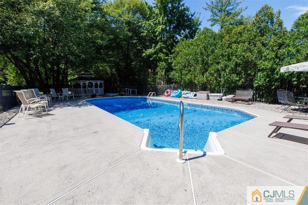 81 Spring Hill Road Old Bridge, NJ 07747 - Photo 10 of 40 a view of a swimming pool with a patio