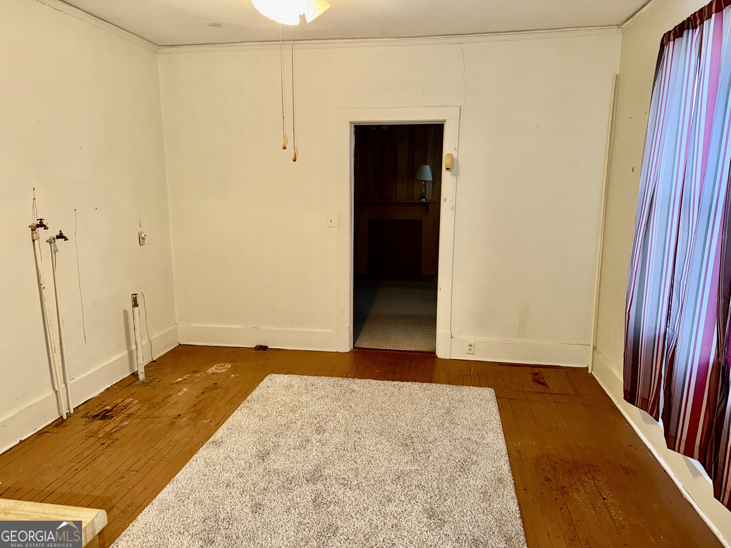 349 Cook Street Elberton, GA 30635 - Photo 17 of 22 an empty room with wooden floor and a bathroom