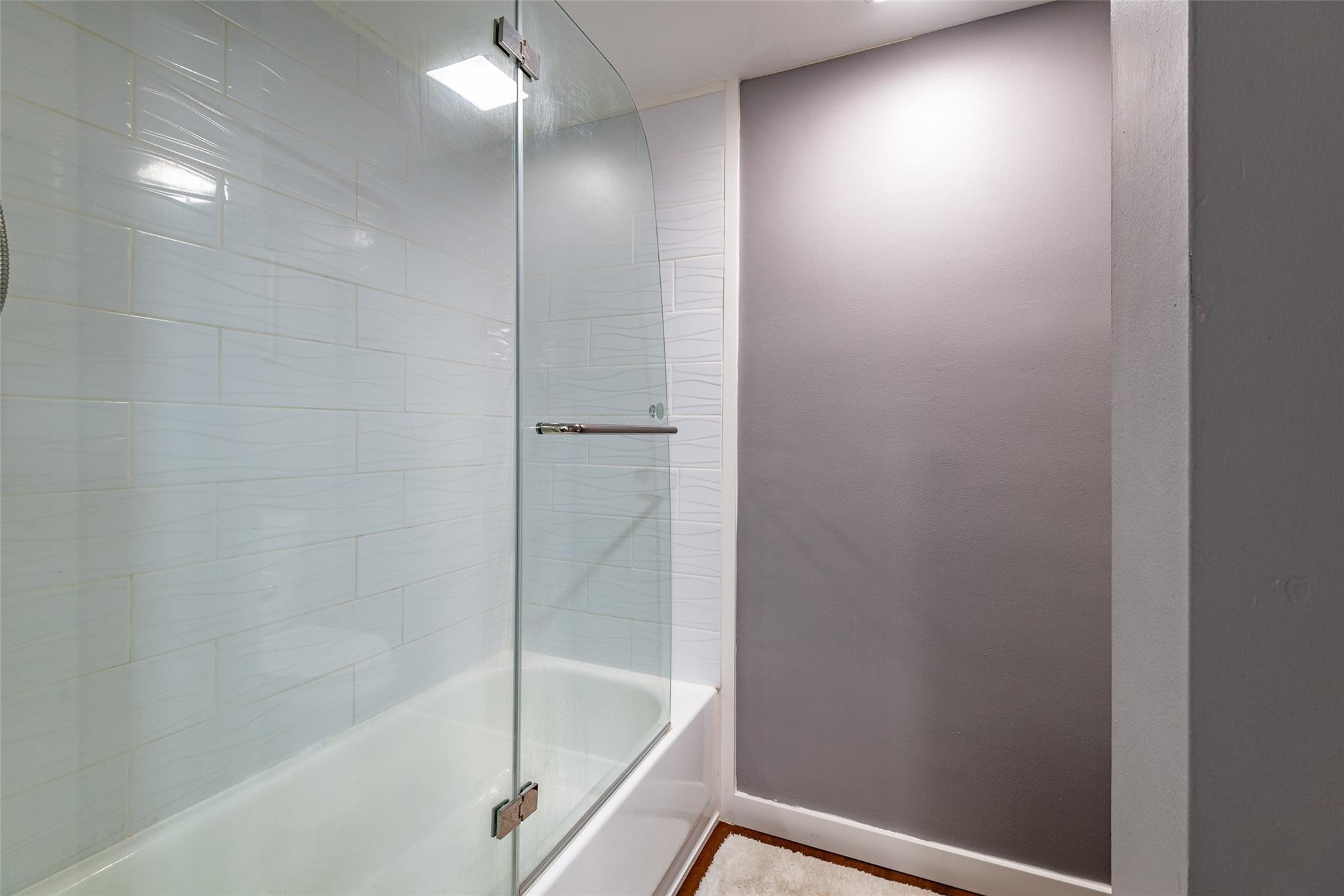 22208 Boca Rancho Drive, Unit D Boca Raton, FL 33428 - Photo 24 of 34 a bathroom with a bathtub and a shower