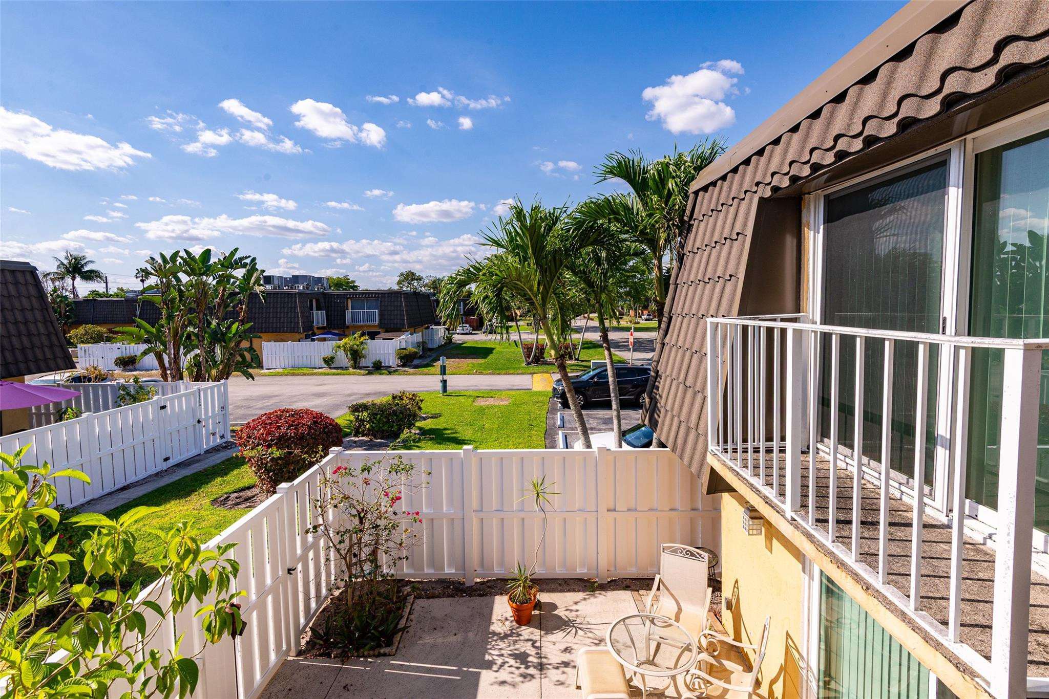 22208 Boca Rancho Drive, Unit D Boca Raton, FL 33428 - Photo 27 of 34 a view of a chair and tables front of the house