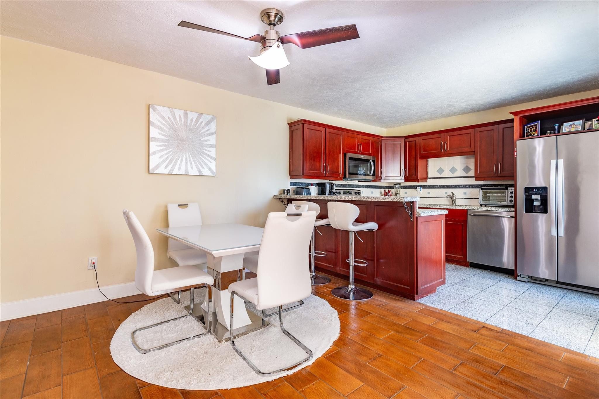 22208 Boca Rancho Drive, Unit D Boca Raton, FL 33428 - Photo 6 of 34 a living room with stainless steel appliances furniture a dining table and chairs