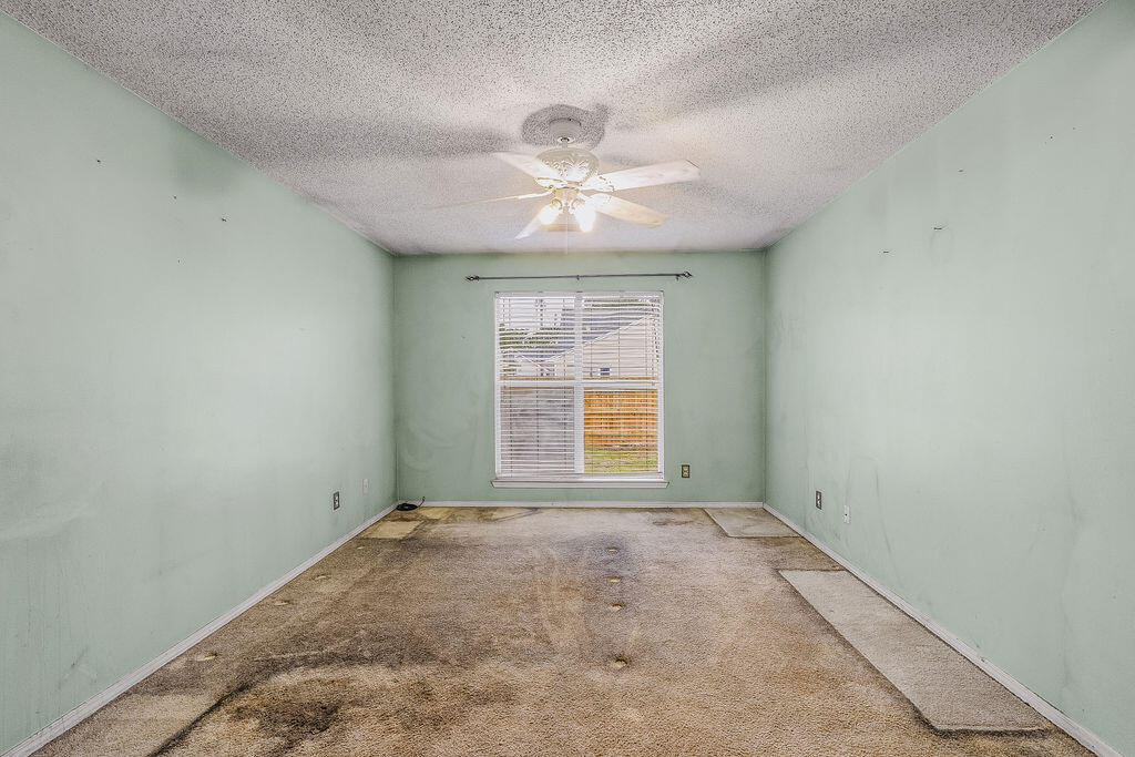 53 4th Street Shalimar, FL 32579 - Photo 24 of 47 an empty room with a window and a fan