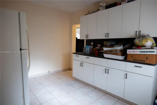 a kitchen with cabinets and appliances