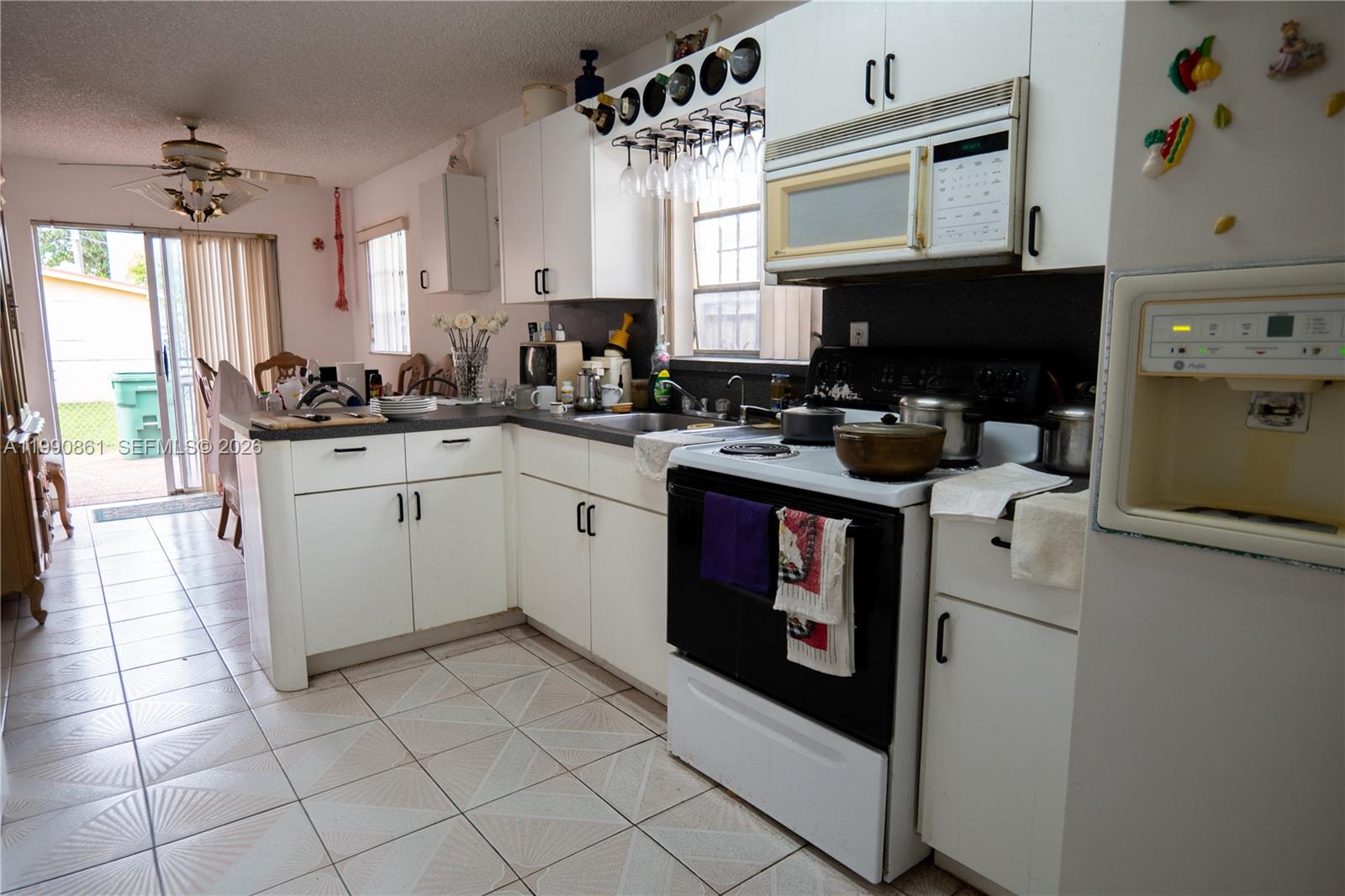 2323 Southwest 17th Terrace Miami, FL 33145 - Photo 13 of 24 a kitchen with a sink stove and cabinets