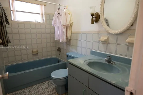 a bathroom with a sink a toilet and bathtub