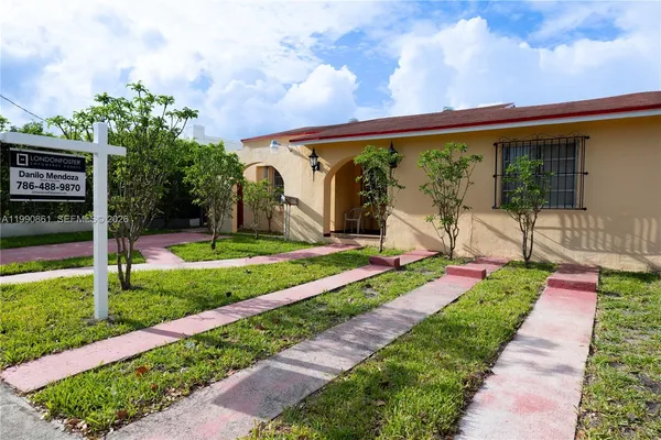 a front view of a house with a yard table and chairs
