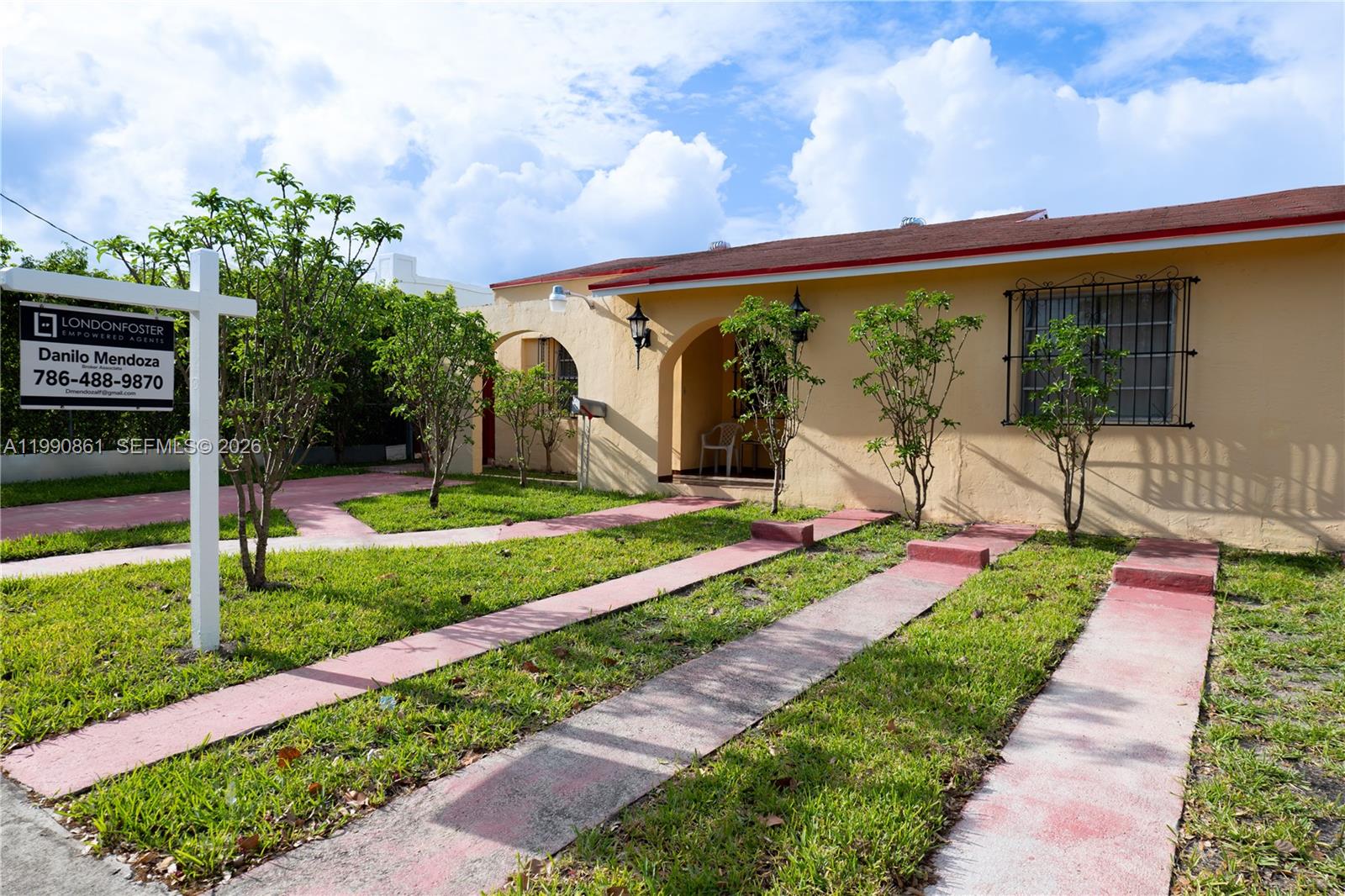 2323 Southwest 17th Terrace Miami, FL 33145 - Photo 3 of 24 a front view of a house with a yard table and chairs