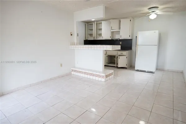 a kitchen with white cabinets and white appliances