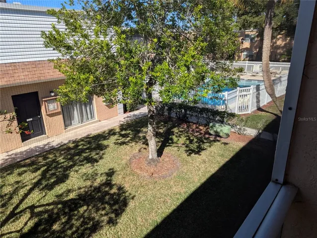 an empty room with a rug and a ceiling fan