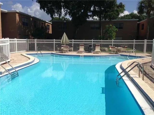 a view of a swimming pool with a patio