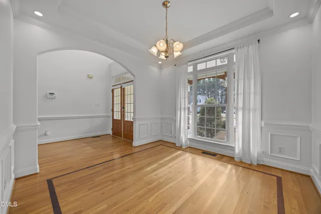 a view of small space with wooden floor and windows