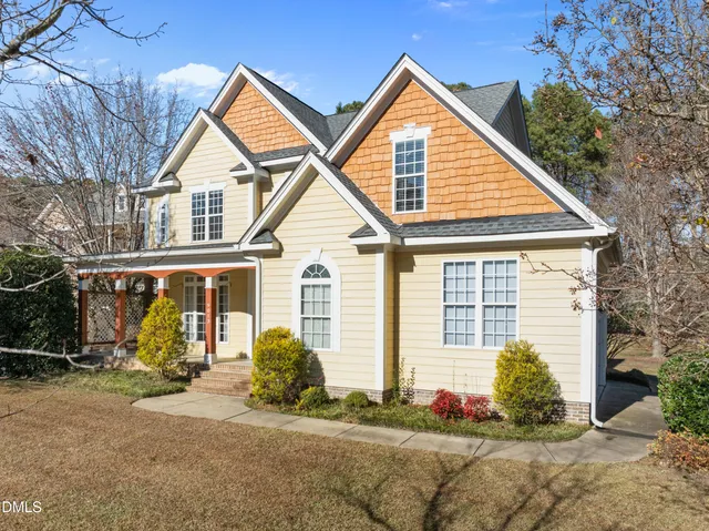 a view of a house with wooden fence