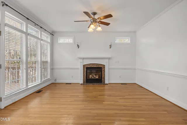 a view of an empty room with a fireplace and a window