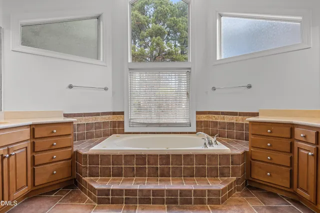 a bathroom with a sink a vanity and a large mirror