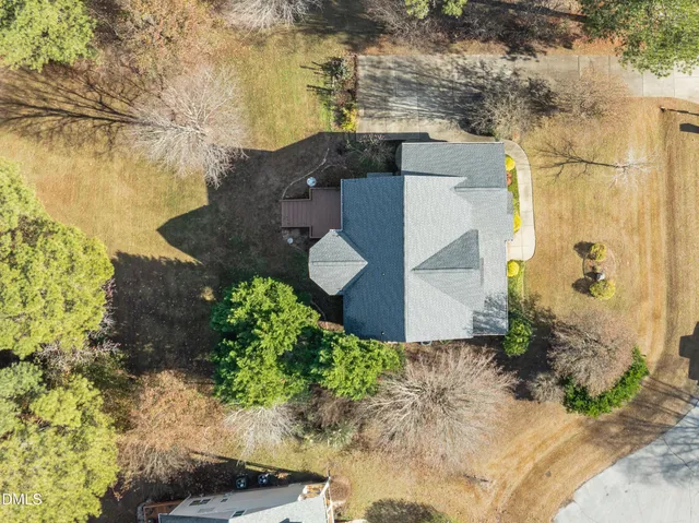an aerial view of a house with a yard