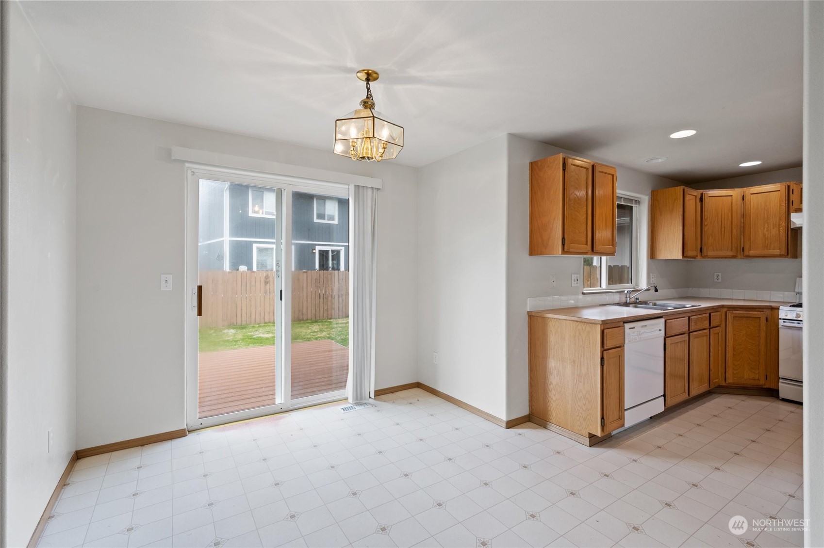 422 Spring Lane Sedro-Woolley, WA 98284 - Photo 6 of 25 a view of a kitchen with a sink and dishwasher with wooden floor