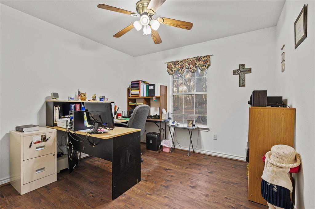 80 Campbell Road Sadler, TX 76264 - Photo 14 of 29 Bedroom used as home office featuring dark LVP flooring, ceiling fan and double door closet