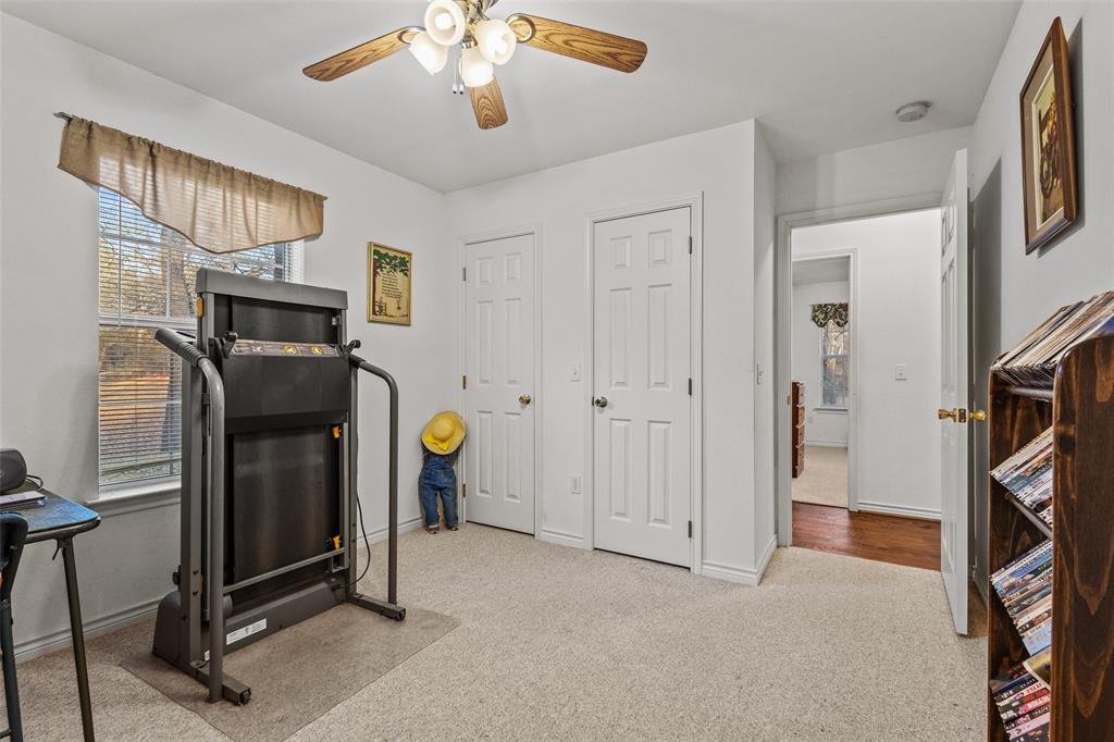 80 Campbell Road Sadler, TX 76264 - Photo 16 of 29 Bedroom featuring ceiling fan, double closet and carpet