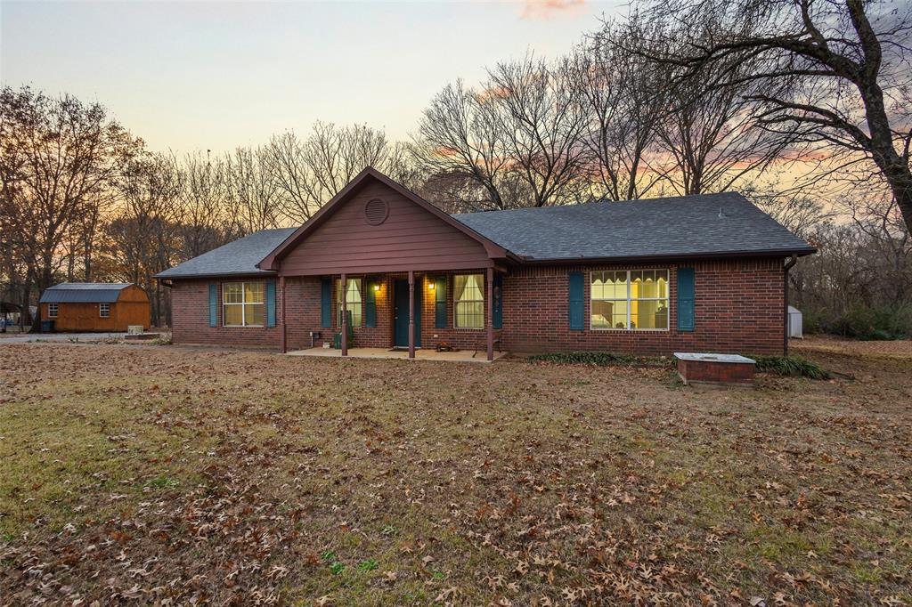 80 Campbell Road Sadler, TX 76264 - Photo 29 of 29 Single story home with brick construction, a covered porch, and a lawn