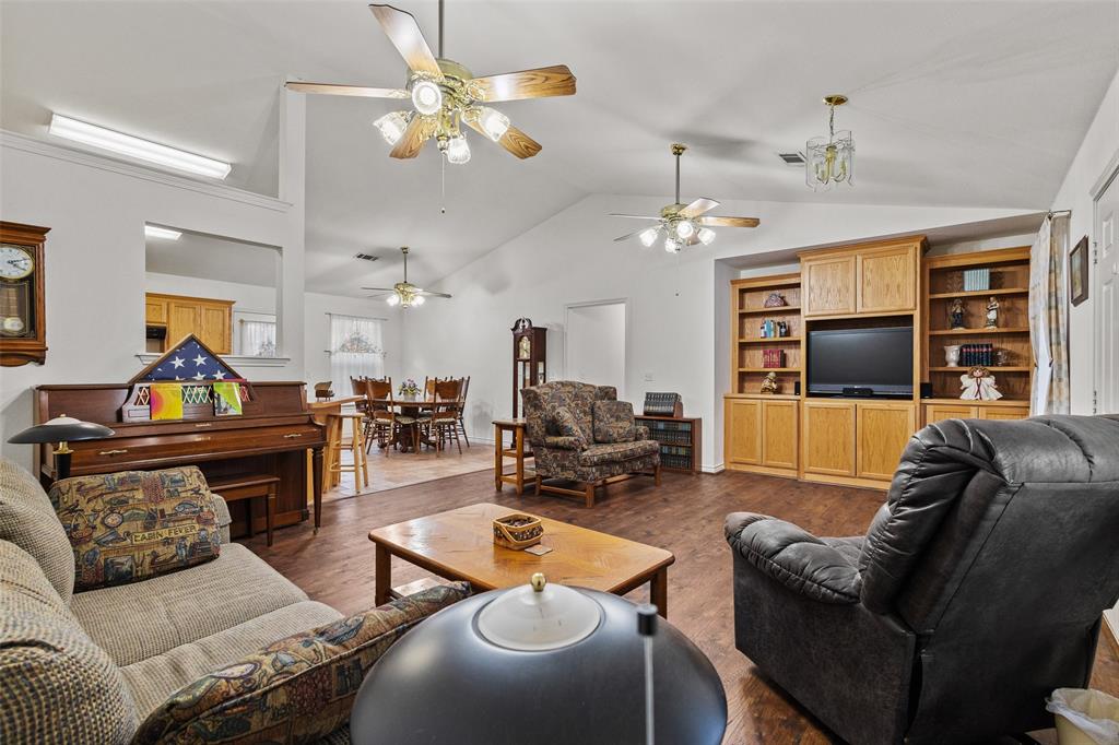 80 Campbell Road Sadler, TX 76264 - Photo 4 of 29 Living room with vaulted ceiling and Luxury Vinyl Plank floors