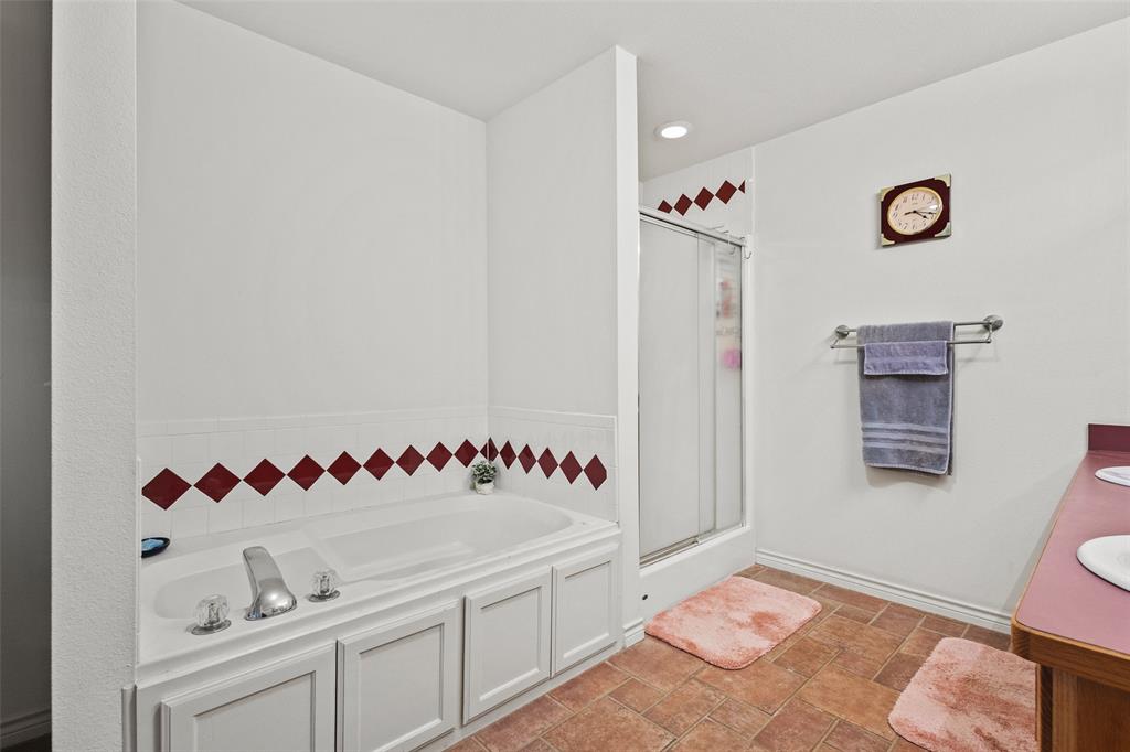 80 Campbell Road Sadler, TX 76264 - Photo 10 of 29 Bathroom with double vanity, a garden tub, a shower stall, stone tile floors, and recessed lighting