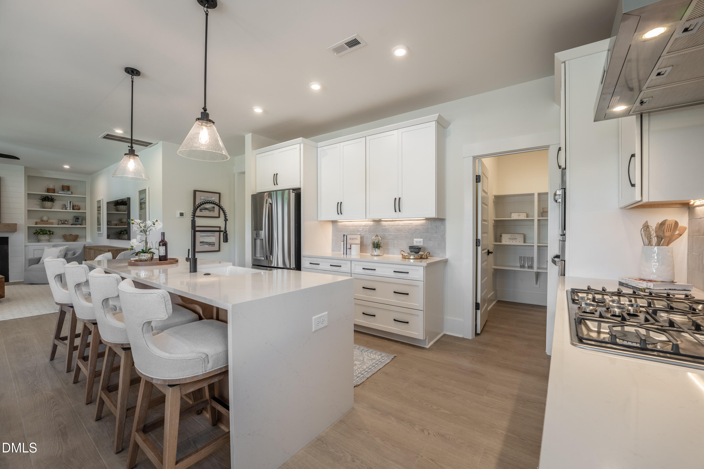 415 Heidi May Way Carthage, NC 28327 - Photo 11 of 48 a kitchen with stainless steel appliances kitchen island granite countertop a table chairs and a refrigerator