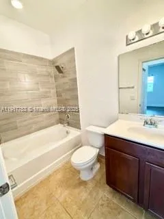a bathroom with a granite countertop sink toilet mirror and bathtub