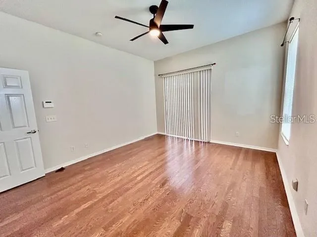 wooden floor in an empty room with a window