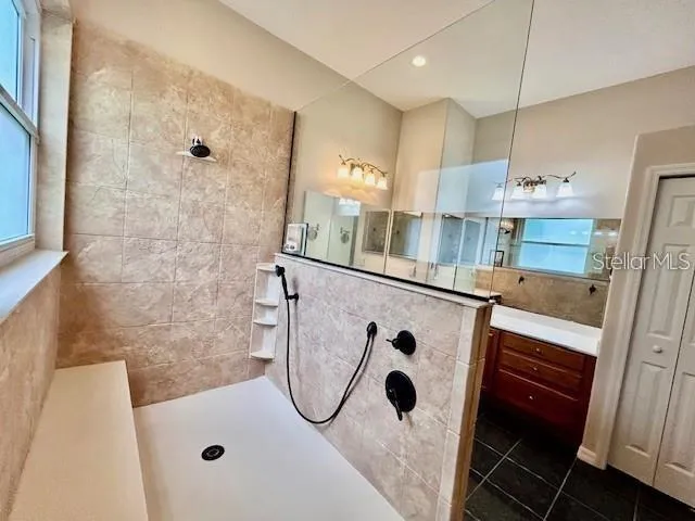 a bathroom with a tub sink and mirror