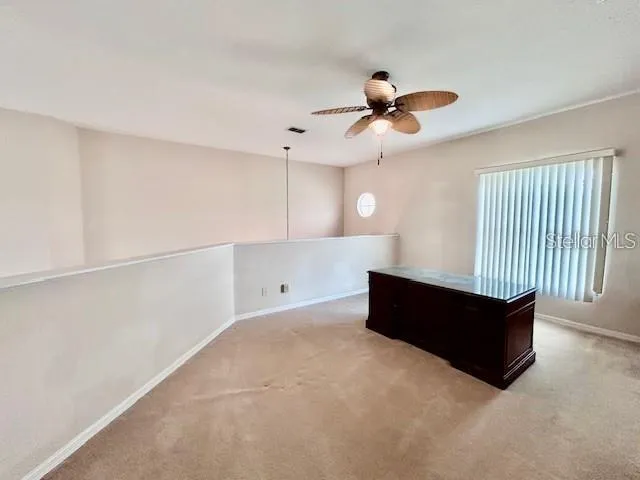 a room with window and a ceiling fan
