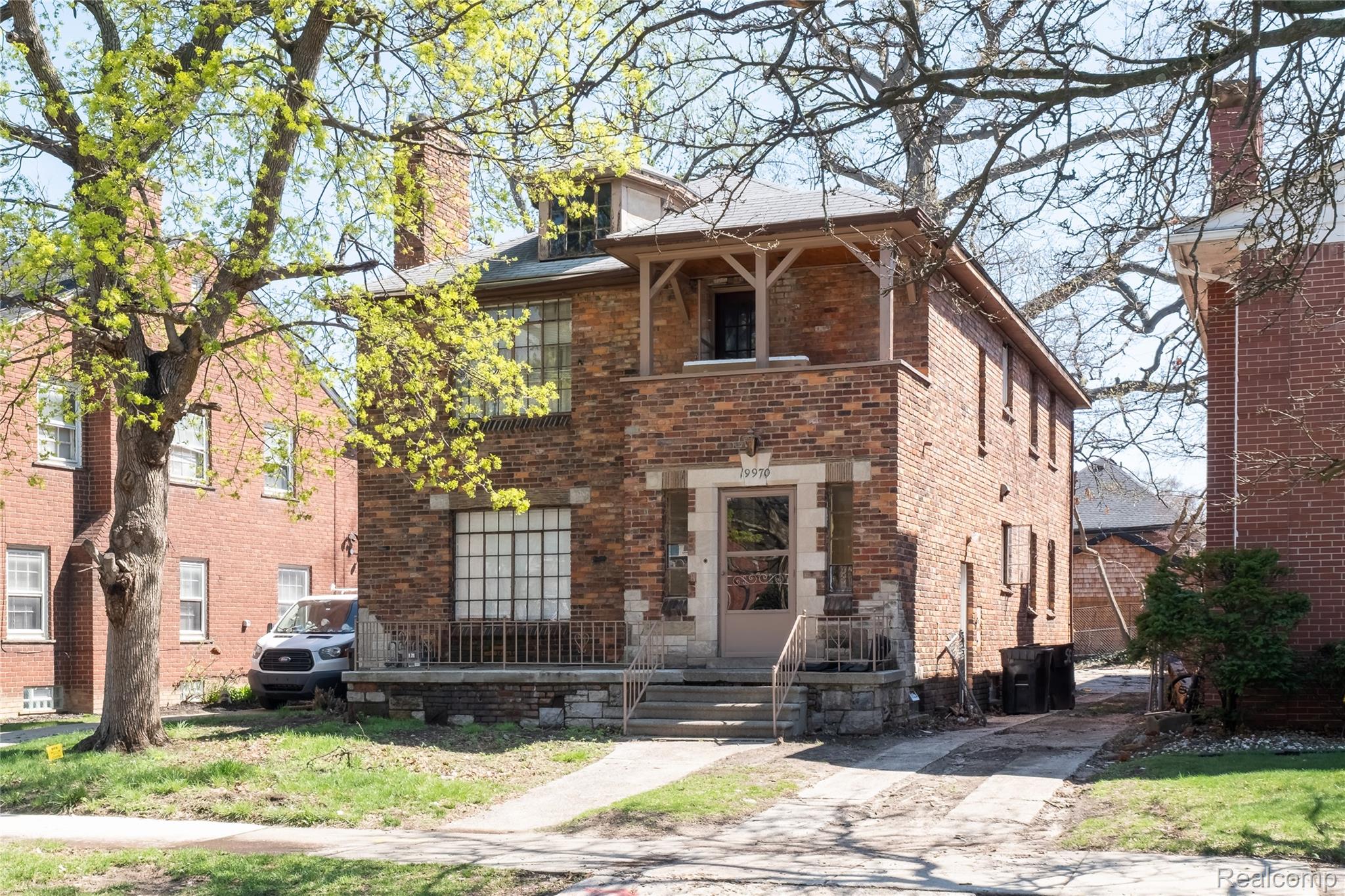 19970 Stratford Road Detroit, MI 48221 - Photo 24 of 27 View of front facade with brick siding and a chimney