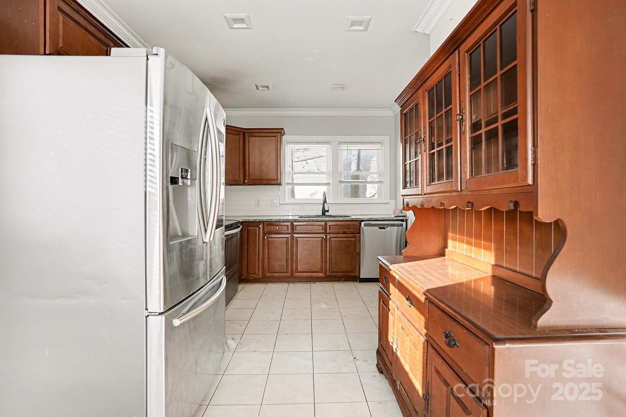 406 South Catawba Street Lancaster, SC 29720 - Photo 19 of 35 a kitchen with stainless steel appliances a sink and a refrigerator