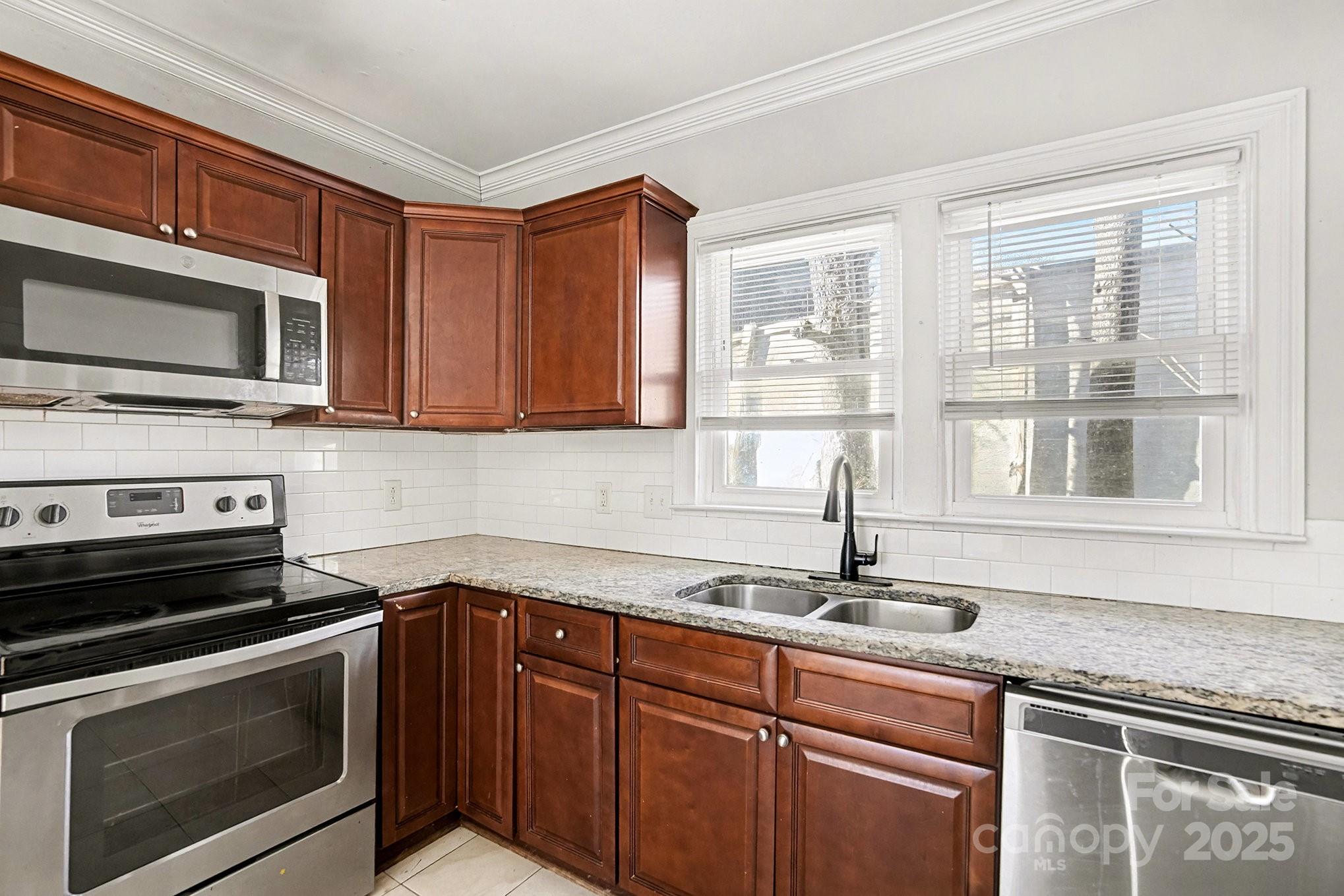 406 South Catawba Street Lancaster, SC 29720 - Photo 20 of 35 a kitchen with stainless steel appliances granite countertop a sink stove and microwave